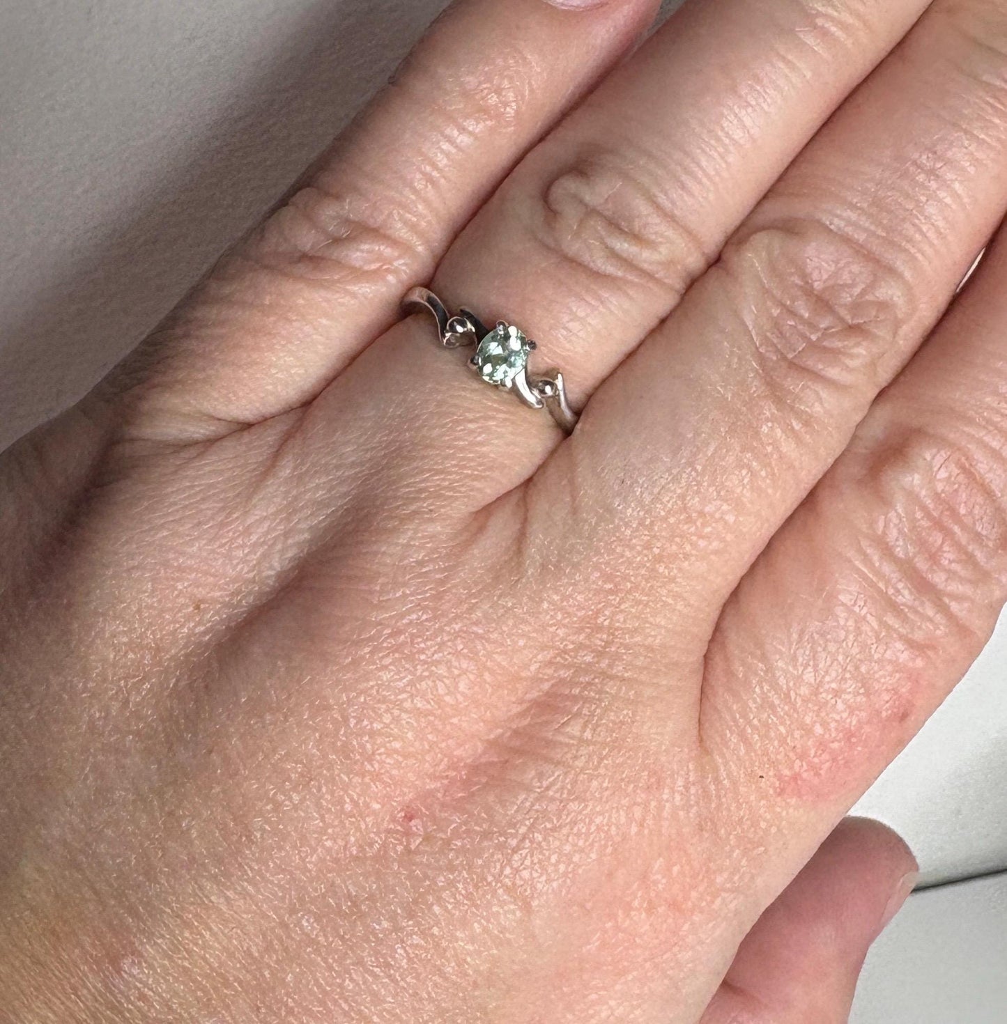 Sterling silver ring with a mint green oval tourmaline gemstone.