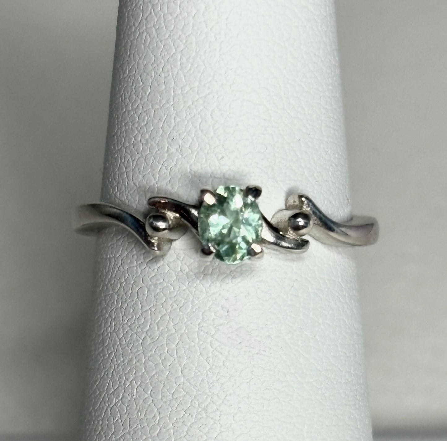 Sterling silver ring with an oval, mint green tourmaline gemstone.