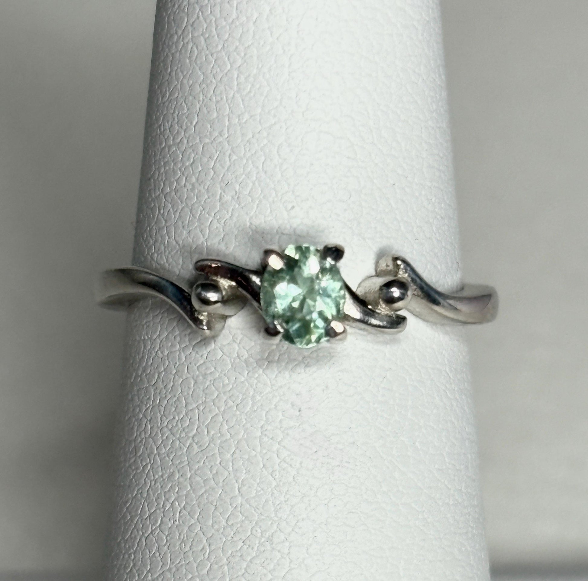 Sterling silver ring with an oval, mint green tourmaline gemstone.