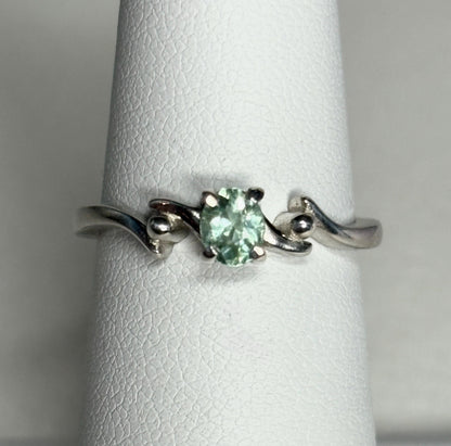 Sterling silver ring with an oval, mint green tourmaline gemstone.