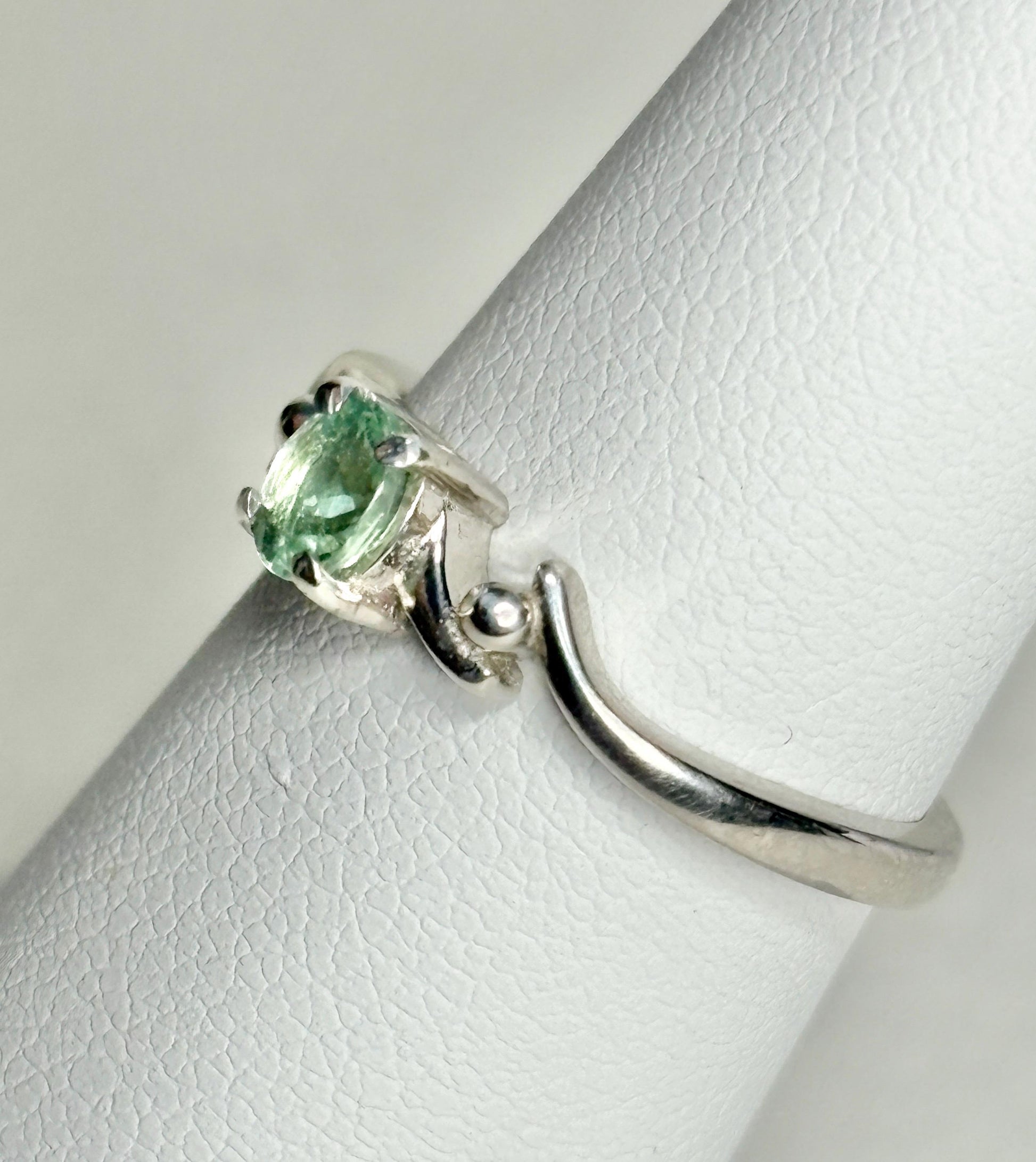 Sterling silver ring with a light green oval tourmaline gemstone.