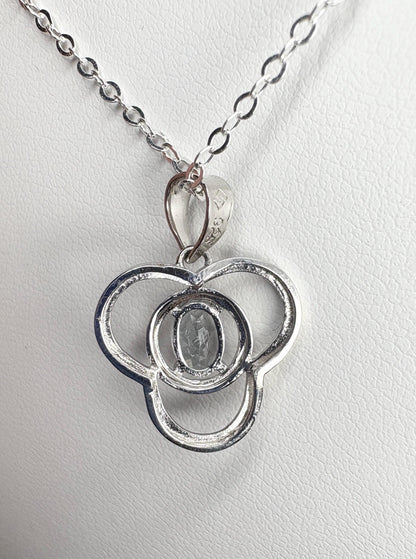 Sterling silver pendant necklace with a clover design and a light blue oval tourmaline.