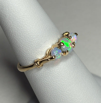 A 14k gold ring with three opals.