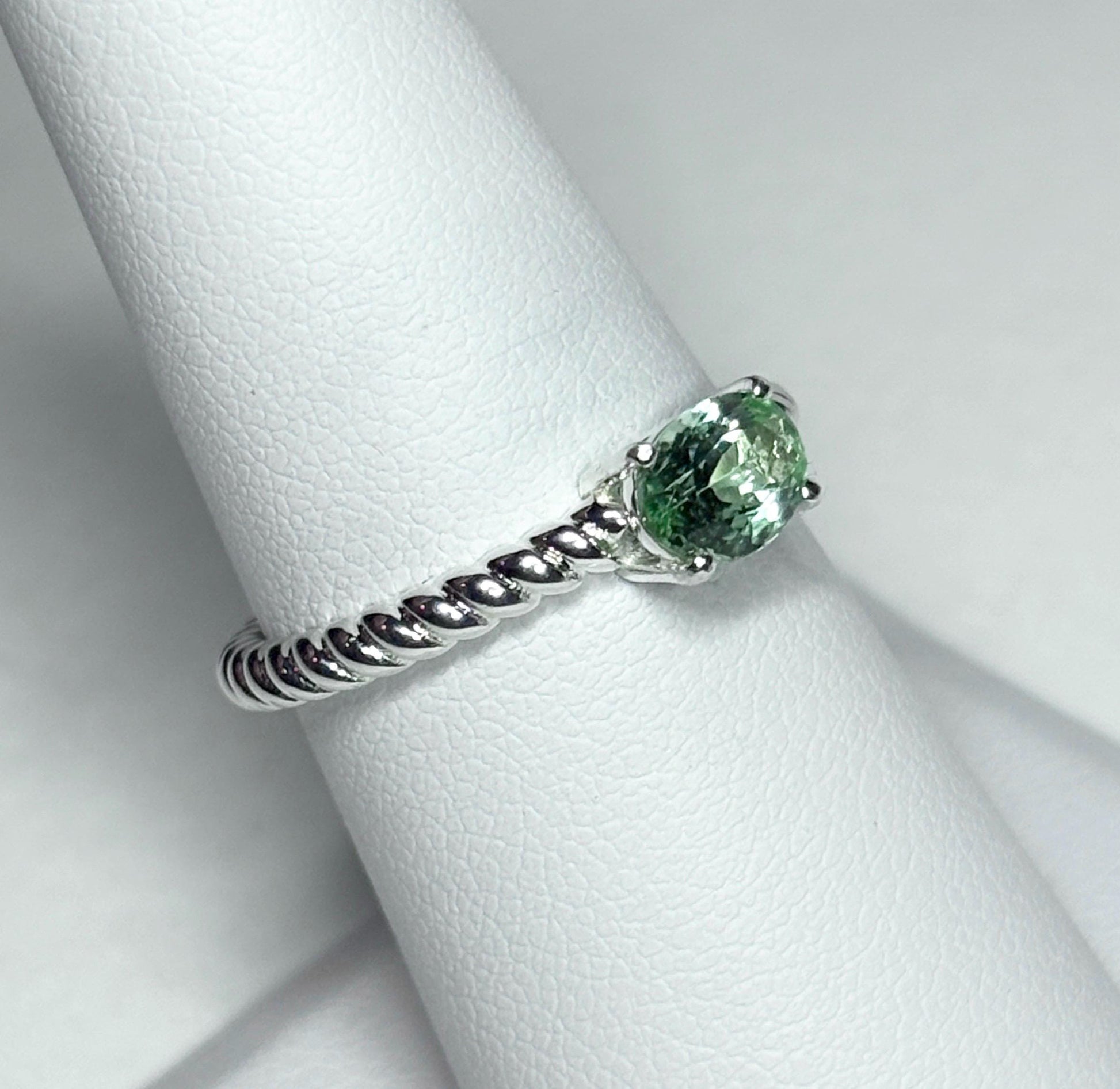 Sterling silver ring with a green oval tourmaline on a rope band.