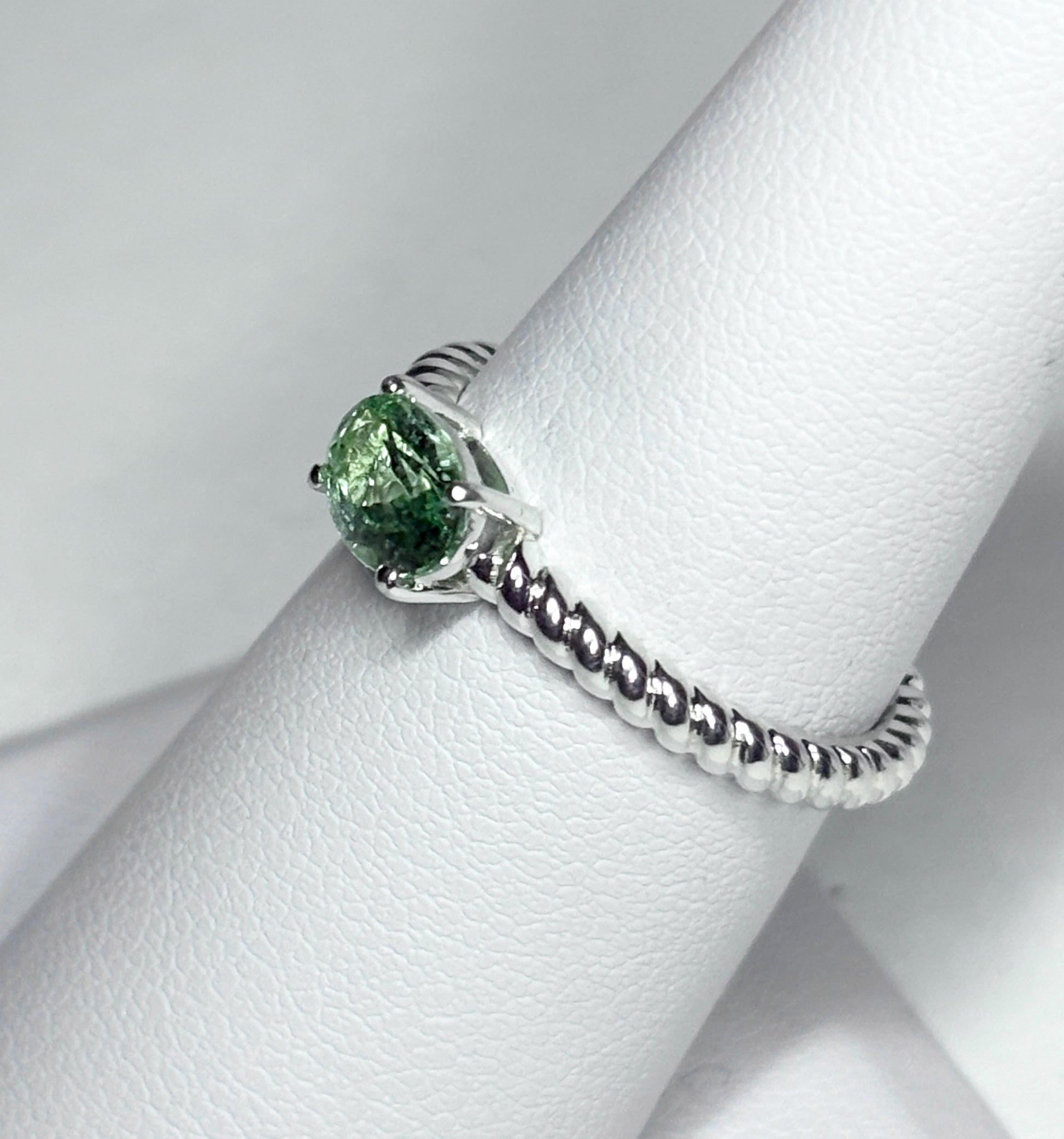 Sterling silver ring with a green oval tourmaline and a rope band.