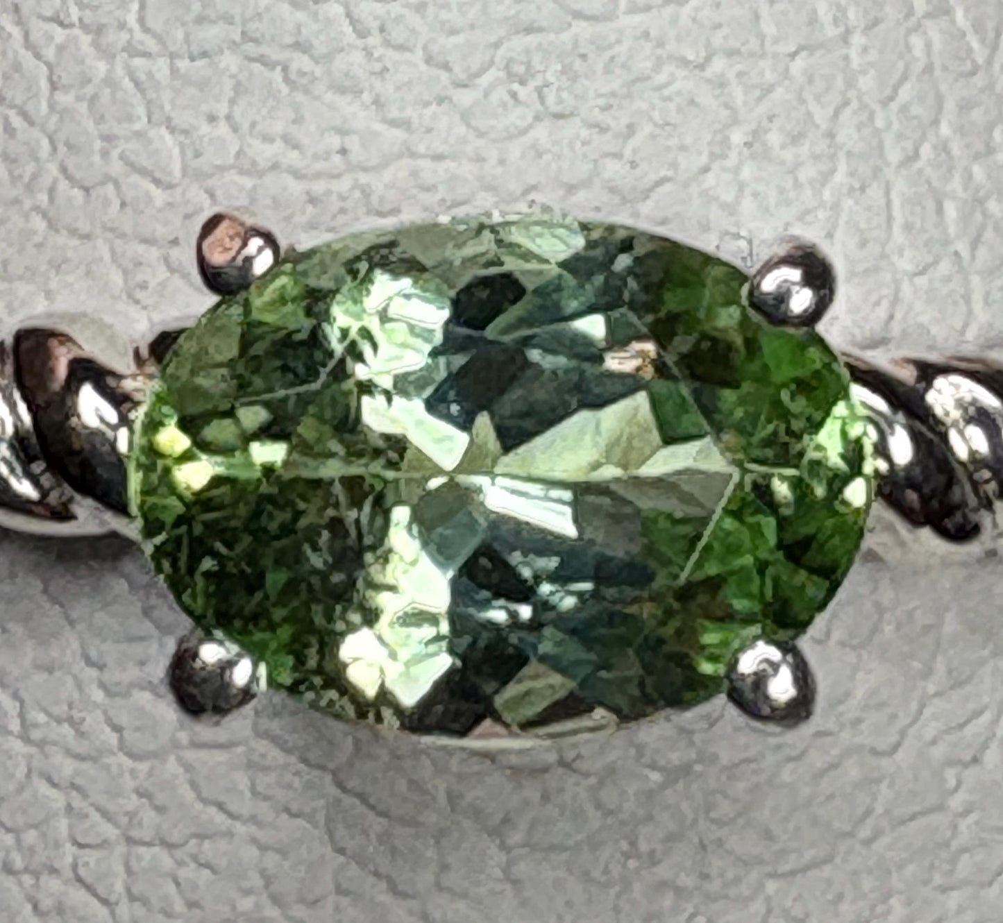 Oval green tourmaline solitaire ring with rope band in sterling silver.