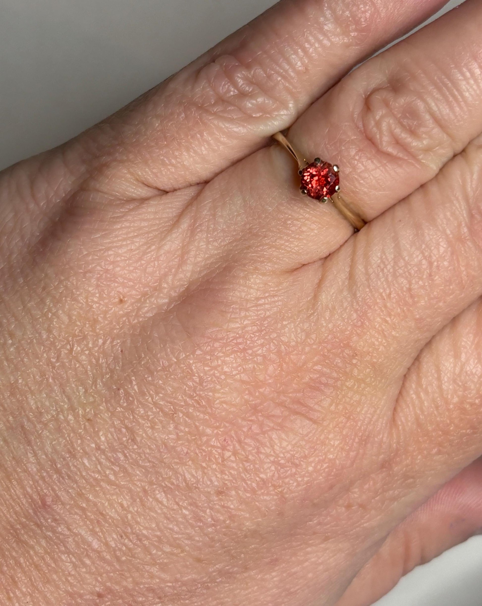 Red Oregon Sunstone solitaire ring in 10k gold.