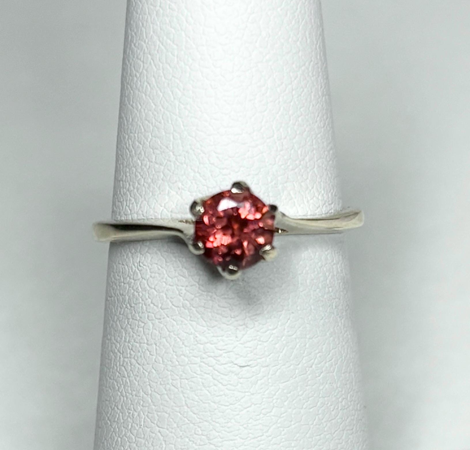 A red Oregon sunstone solitaire ring in solid 10k gold.