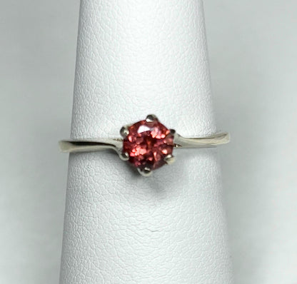 A red Oregon sunstone solitaire ring in solid 10k gold.