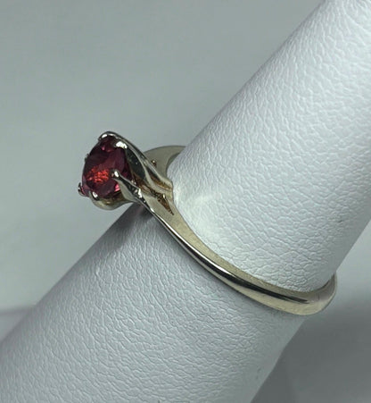 A 10k gold ring with a round red Oregon sunstone.