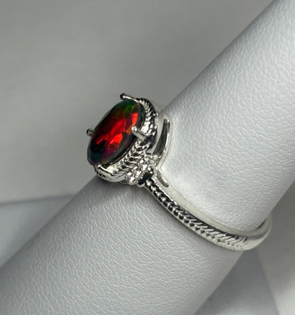 Oval Ethiopian black opal ring with red and green flashes in sterling silver.
