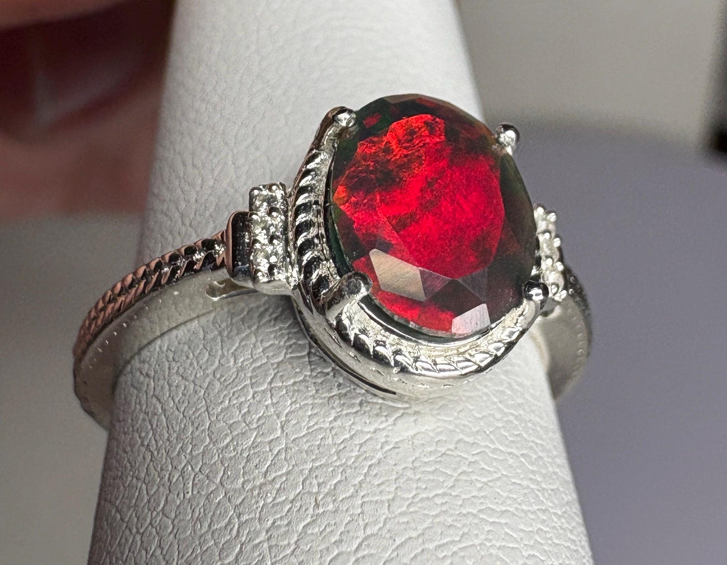 Oval Ethiopian black opal ring with red and green flashes in sterling silver.