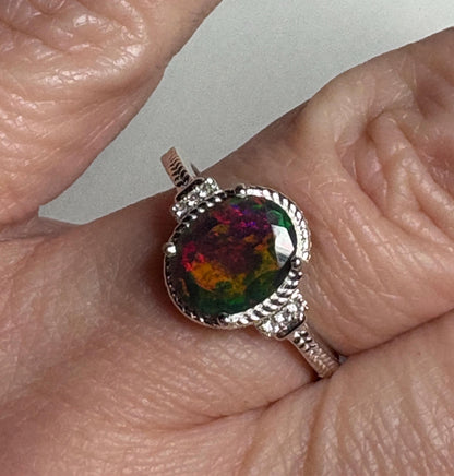 Oval Ethiopian black opal ring with red and green flashes in sterling silver.