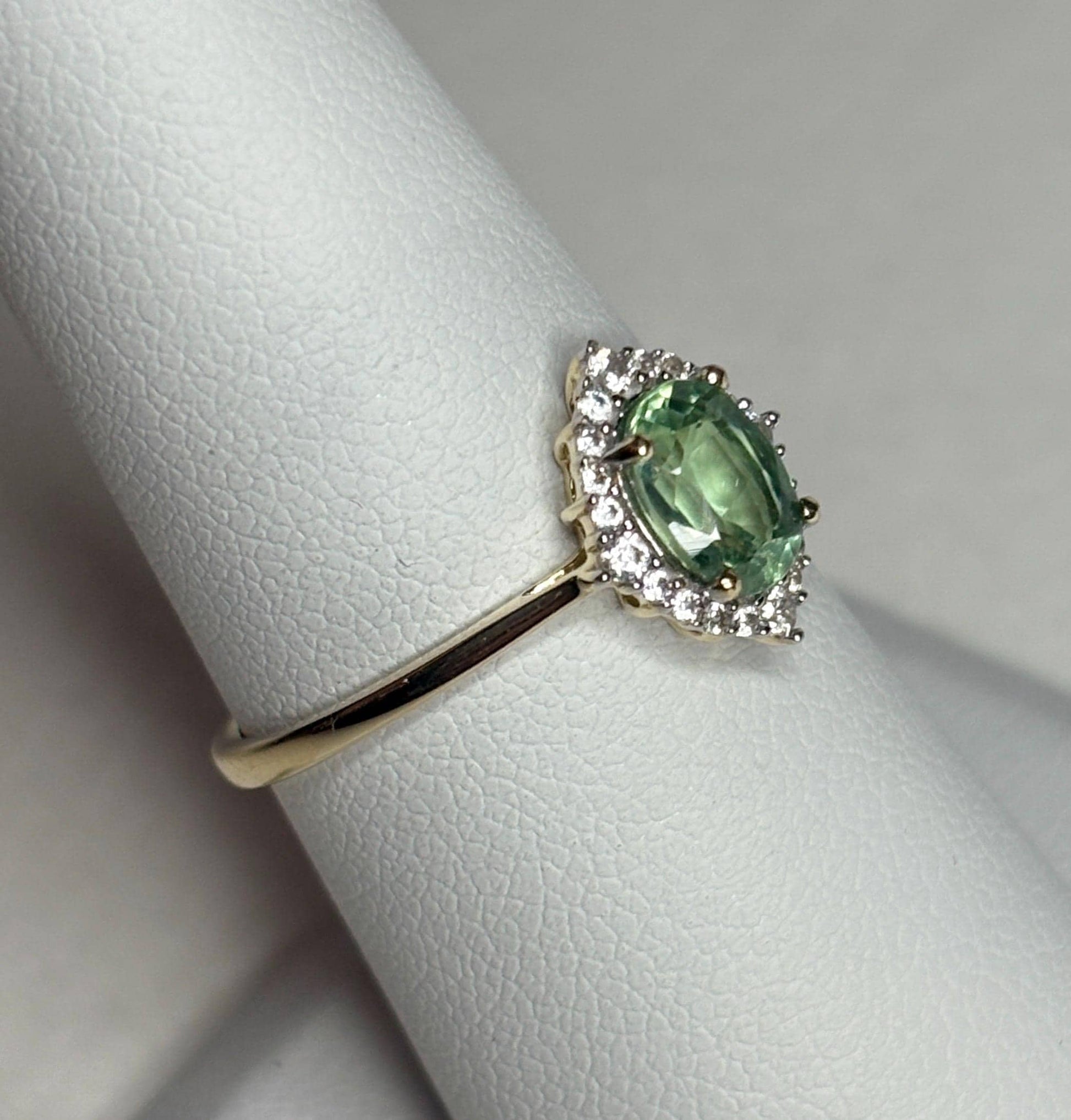 Mint green kyanite and zircon halo ring in solid 9k gold.
