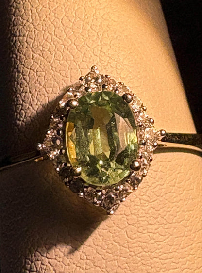 A mint green kyanite and zircon halo ring in solid 9k gold.