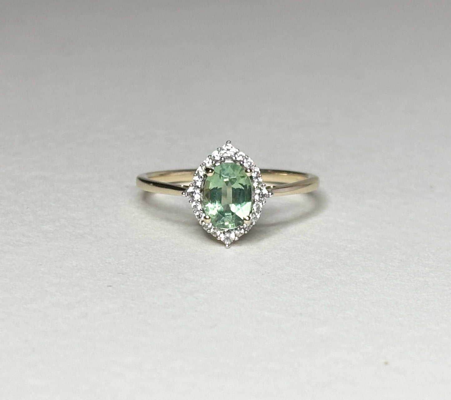 Mint green kyanite and zircon halo ring in solid 9k gold.