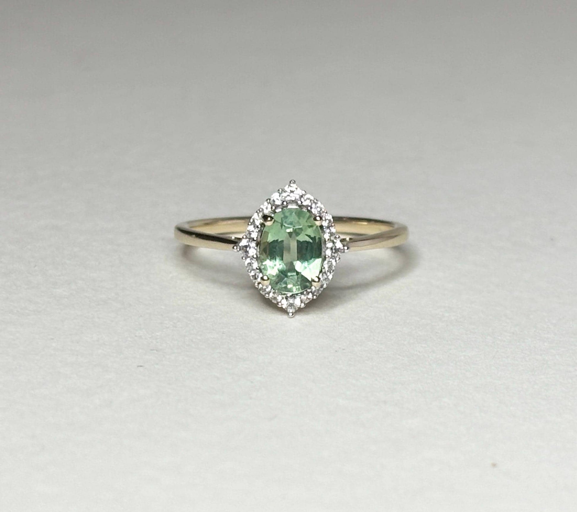 Mint green kyanite and zircon halo ring in solid 9k gold.