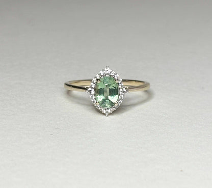 Mint green kyanite and zircon halo ring in solid 9k gold.