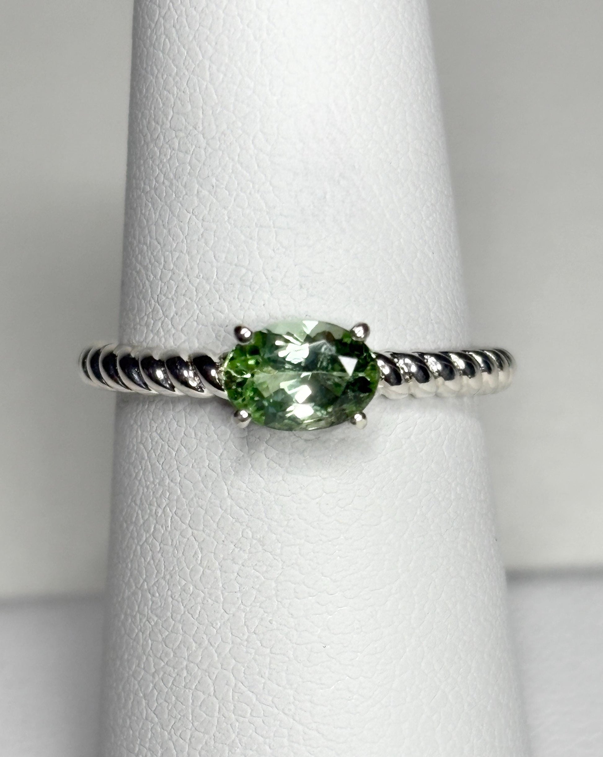 Sterling silver ring with an oval green tourmaline on a rope band.