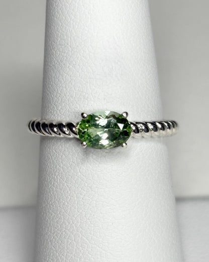 Sterling silver ring with an oval green tourmaline on a rope band.