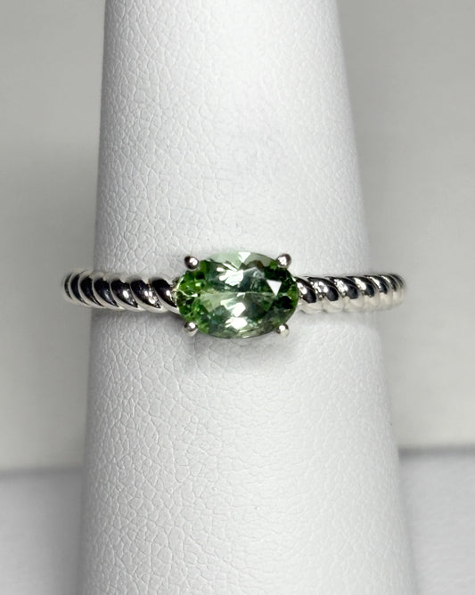 Sterling silver ring with an oval green tourmaline on a rope band.