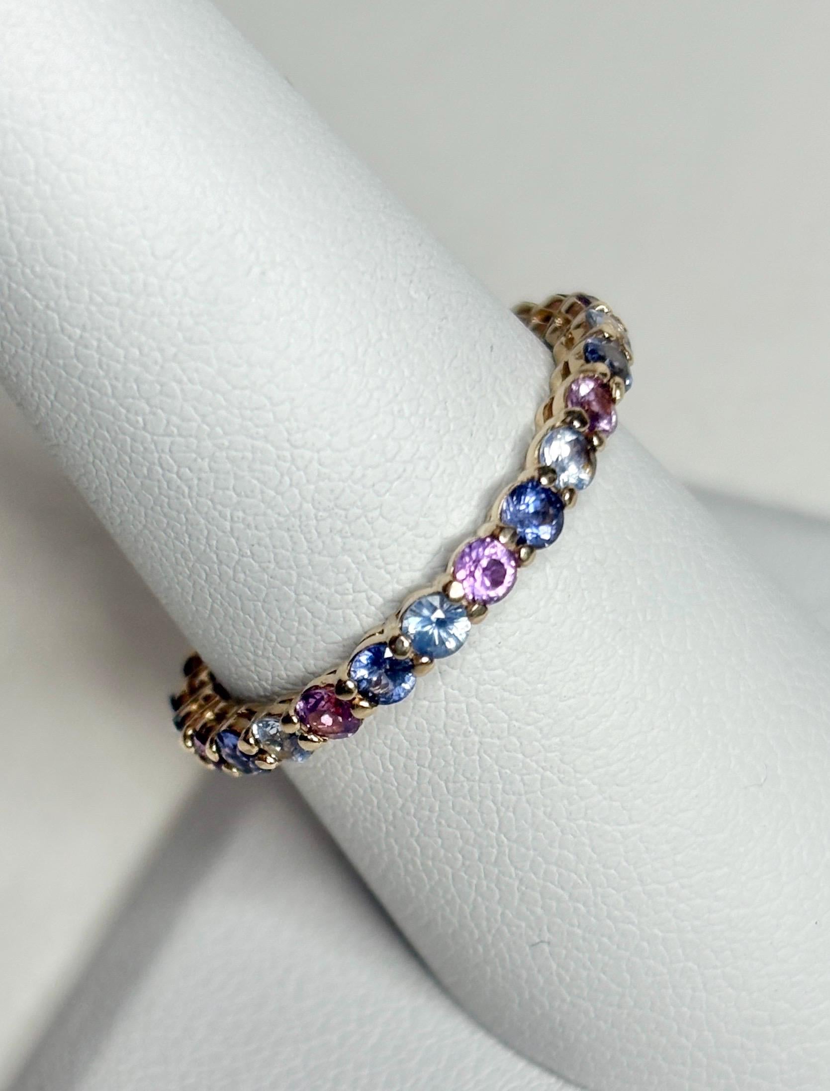 14k gold eternity ring with multi-color sapphires.