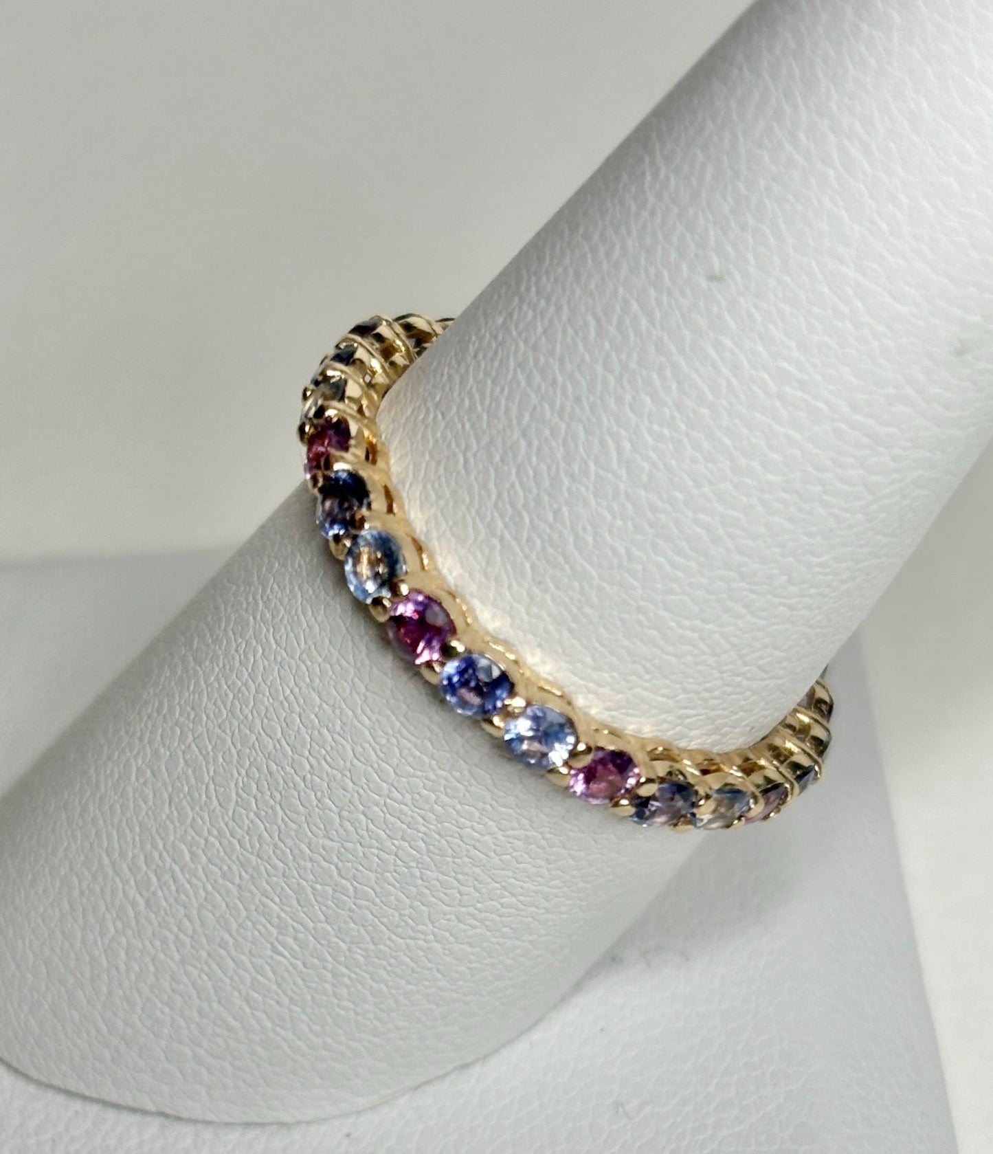 14k gold eternity band with multi-color sapphires.