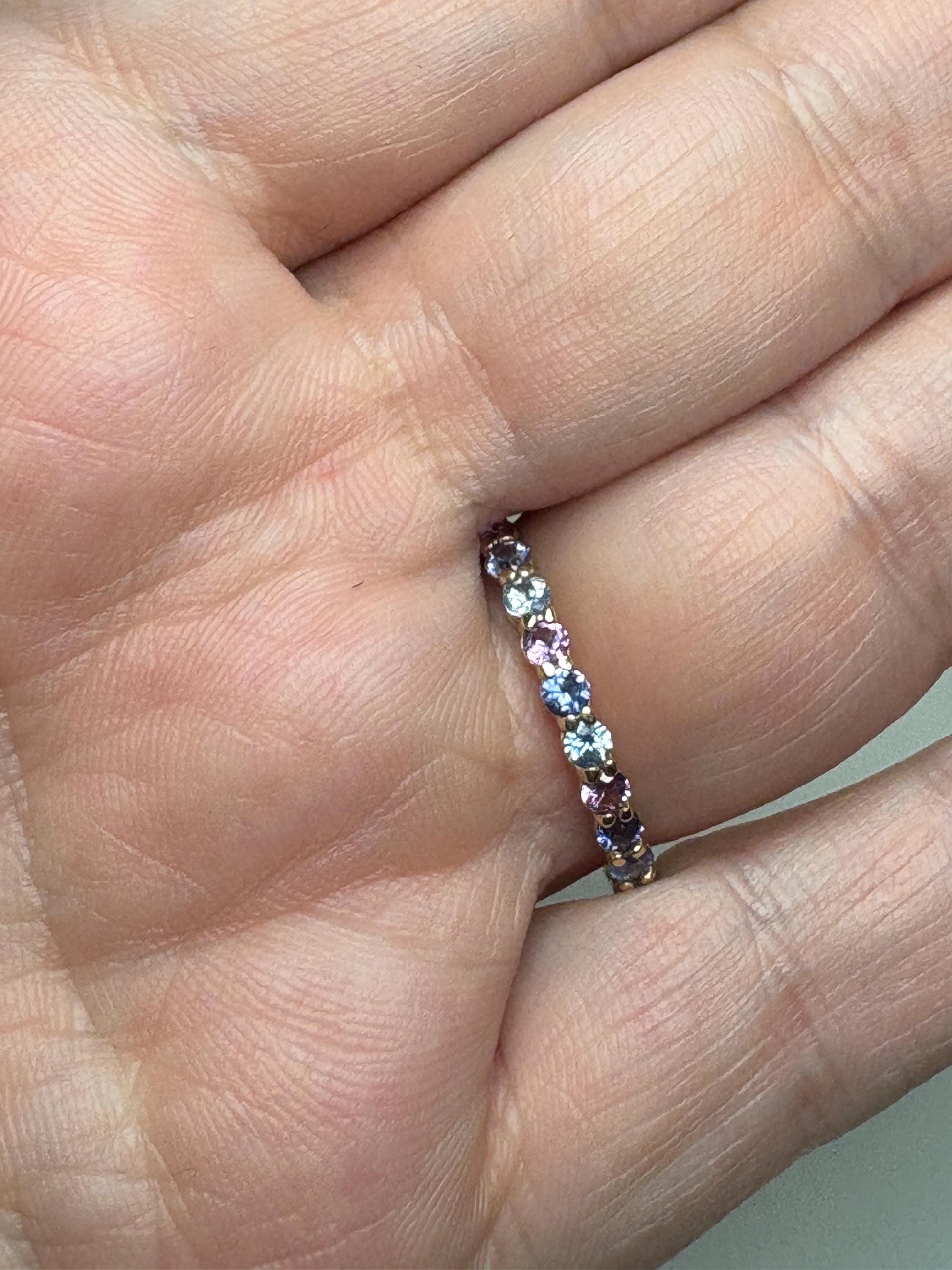 14k gold eternity band with multi-color sapphires.