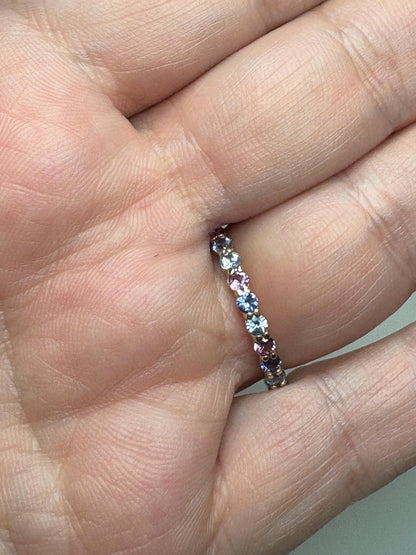 14k gold eternity band with multi-color sapphires.