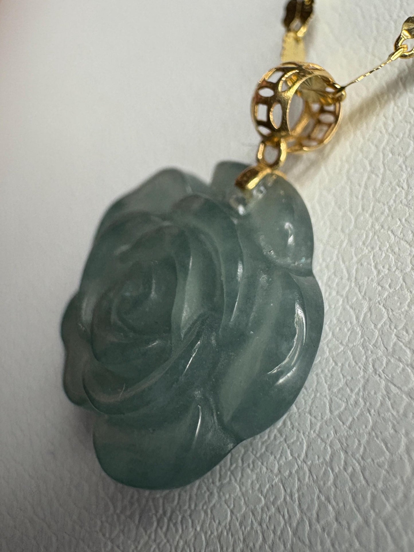 Teal jadeite rose pendant on an 18k gold bail and 14k gold chain.