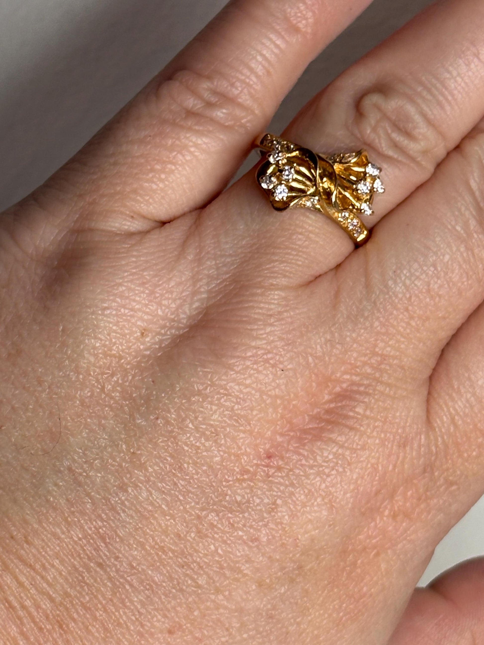 Solid 21k gold bypass ring with white stones, size 8.5.