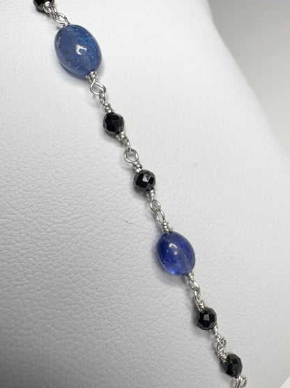 Sterling silver bracelet with oval tanzanite and faceted black diamond beads.