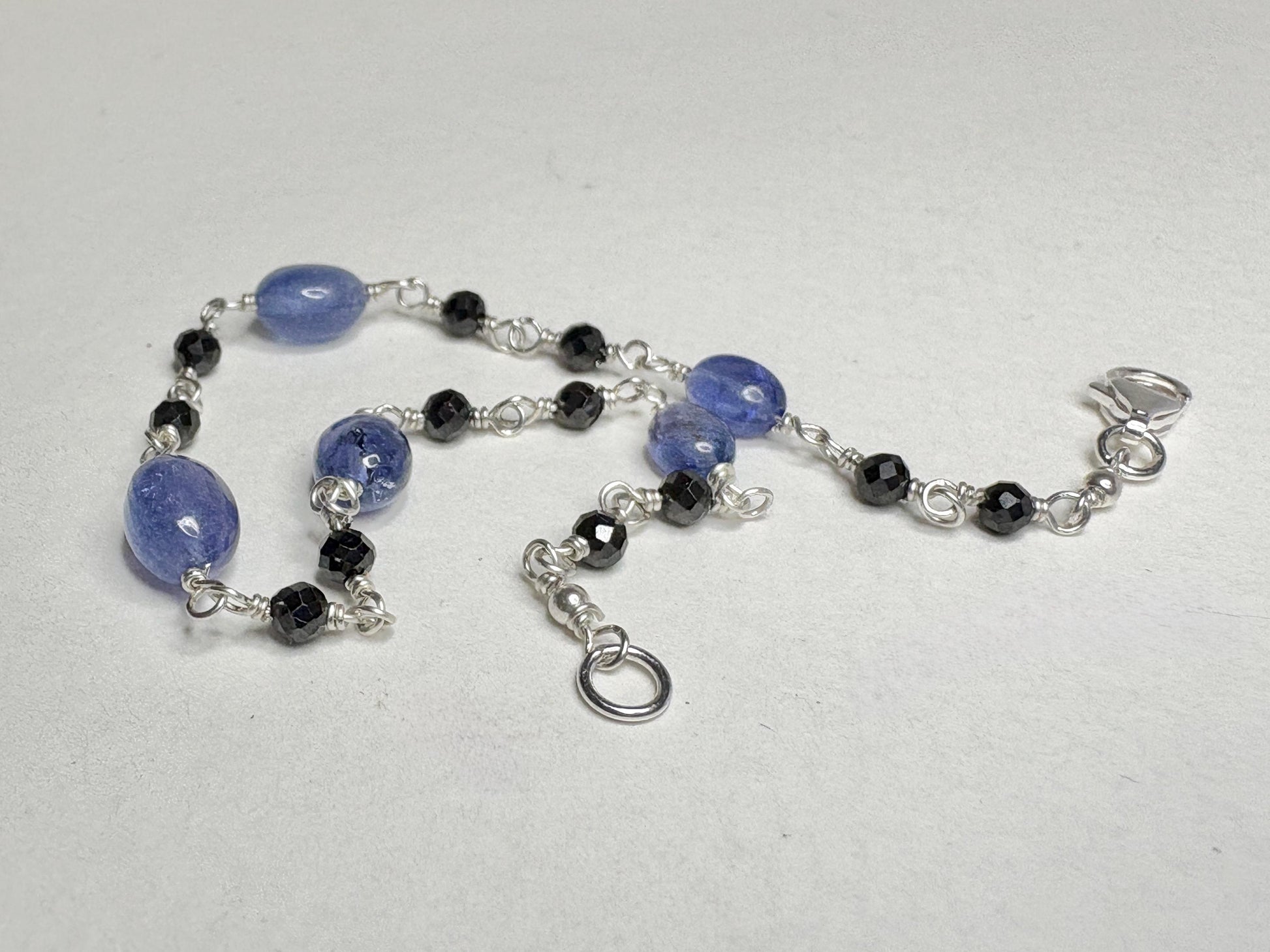 Sterling silver bracelet with black diamond and tanzanite beads.