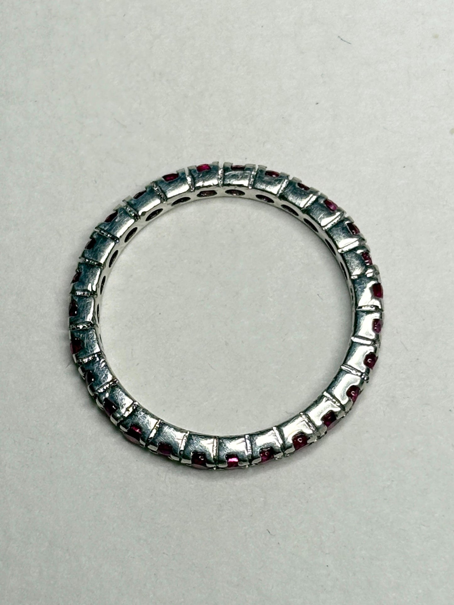 Hot pink lab-grown sapphire eternity ring in sterling silver.