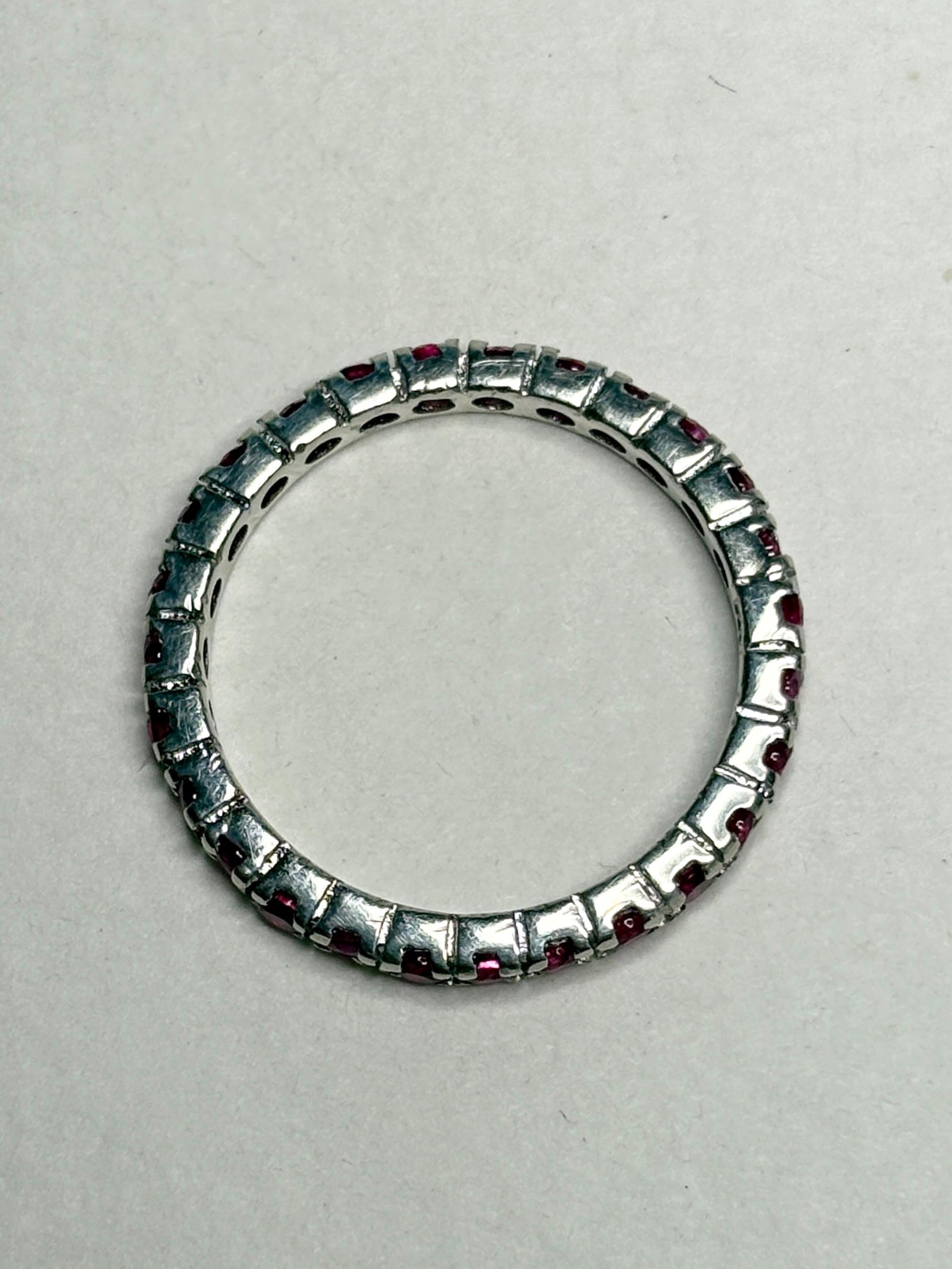 Hot pink lab-grown sapphire eternity ring in sterling silver.