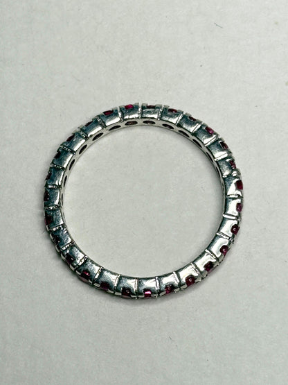 Hot pink lab-grown sapphire eternity ring in sterling silver.