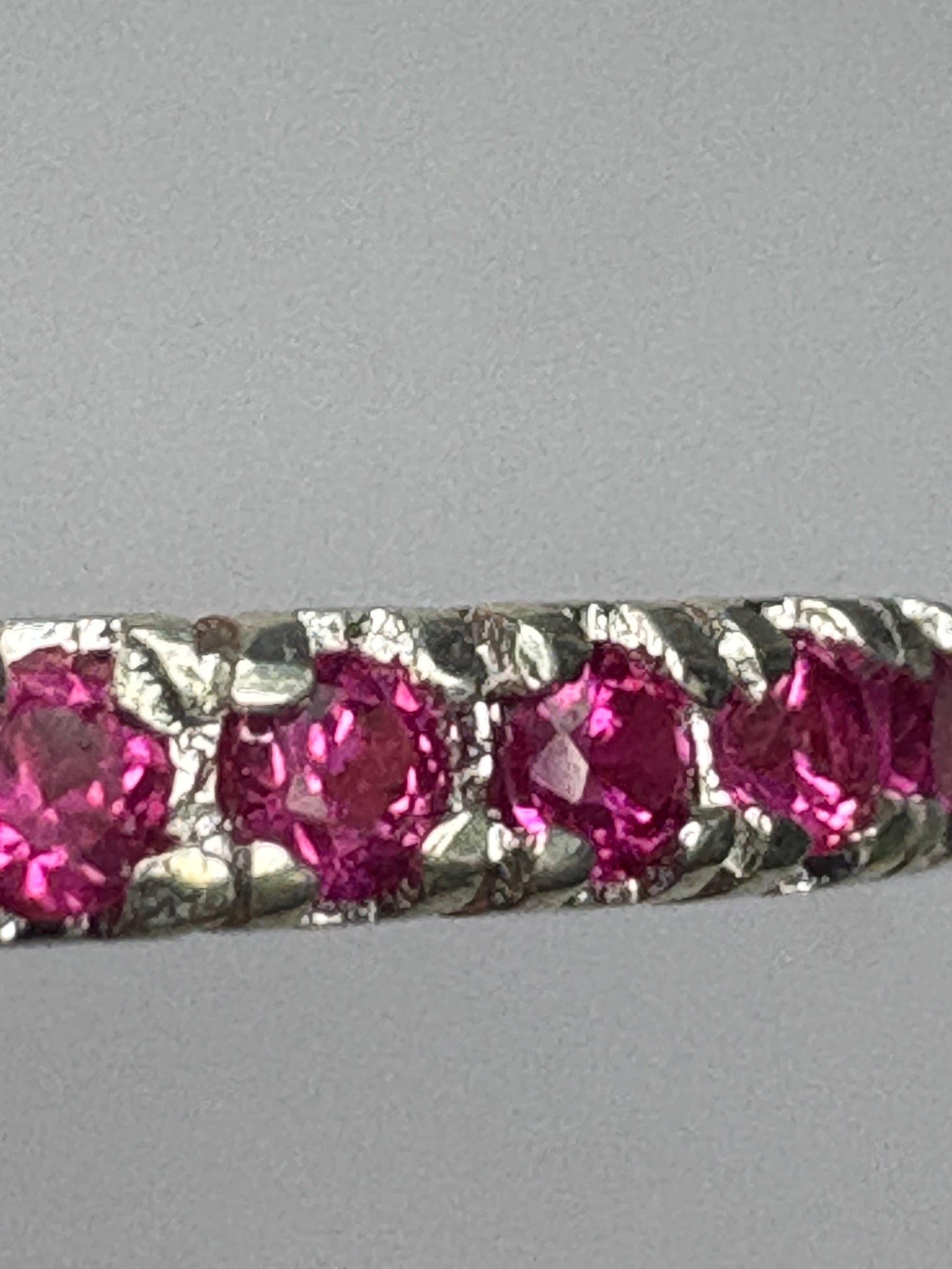 Hot pink lab-grown sapphire eternity ring in solid sterling silver.