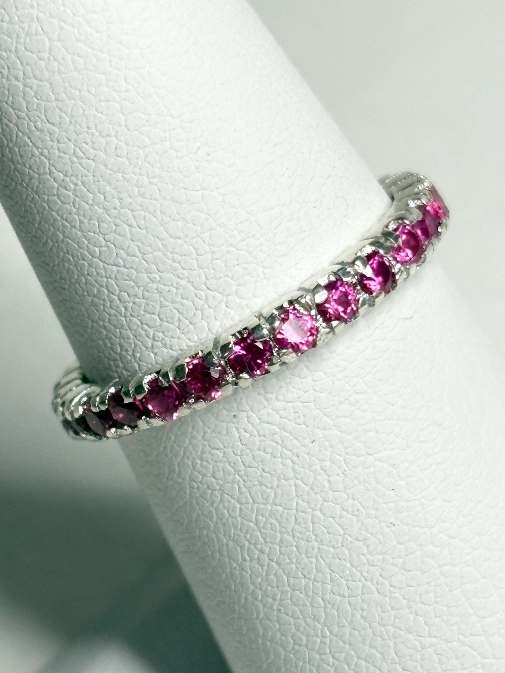 Hot pink lab-grown sapphire eternity ring in sterling silver.