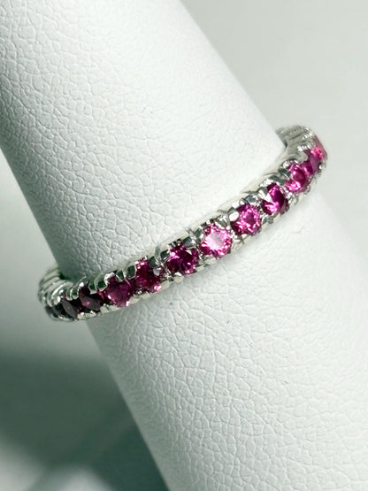 Hot pink lab-grown sapphire eternity ring in sterling silver.