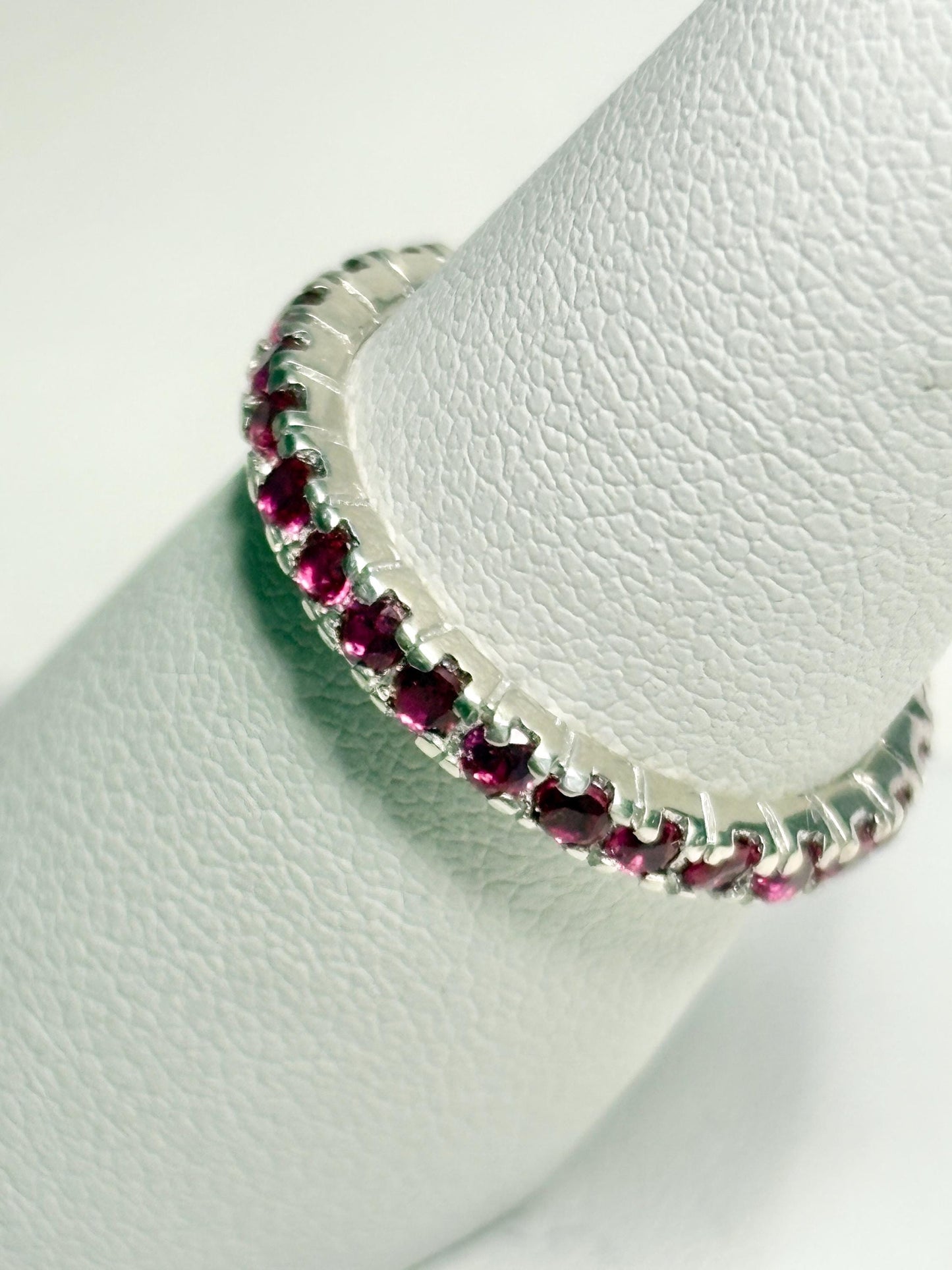 Hot pink lab-grown sapphire eternity ring in sterling silver.