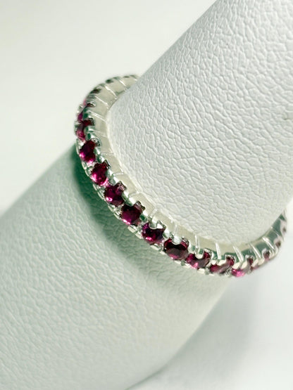 Hot pink lab-grown sapphire eternity ring in sterling silver.