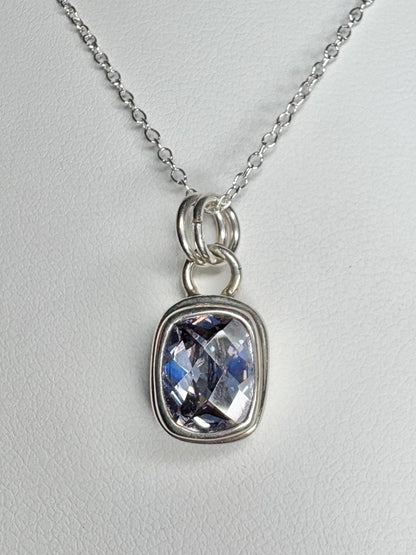 Sterling silver necklace with a bezel-set lavender checkerboard faceted CZ pendant.