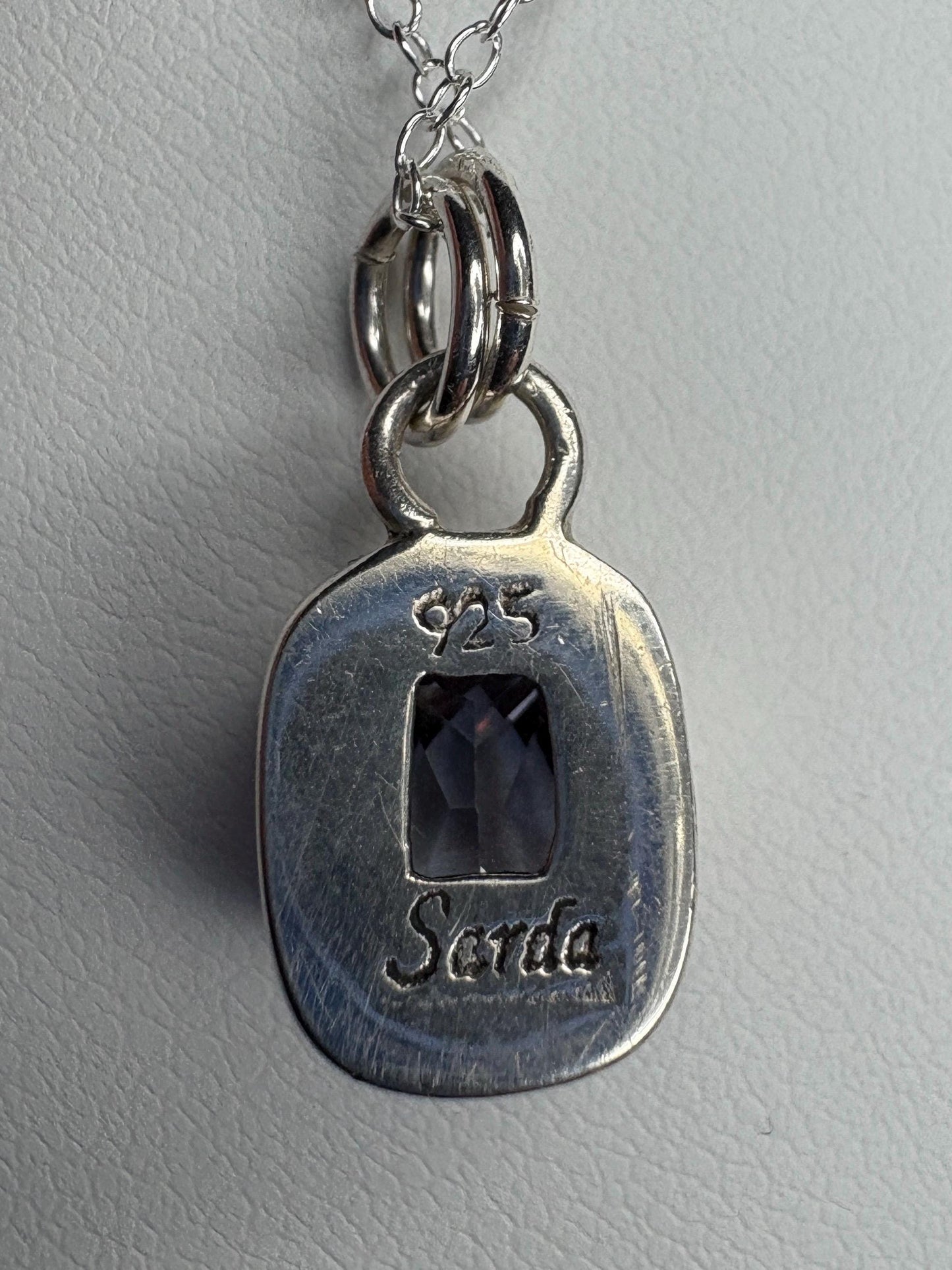 Sterling silver pendant necklace with a lavender checkerboard faceted CZ.