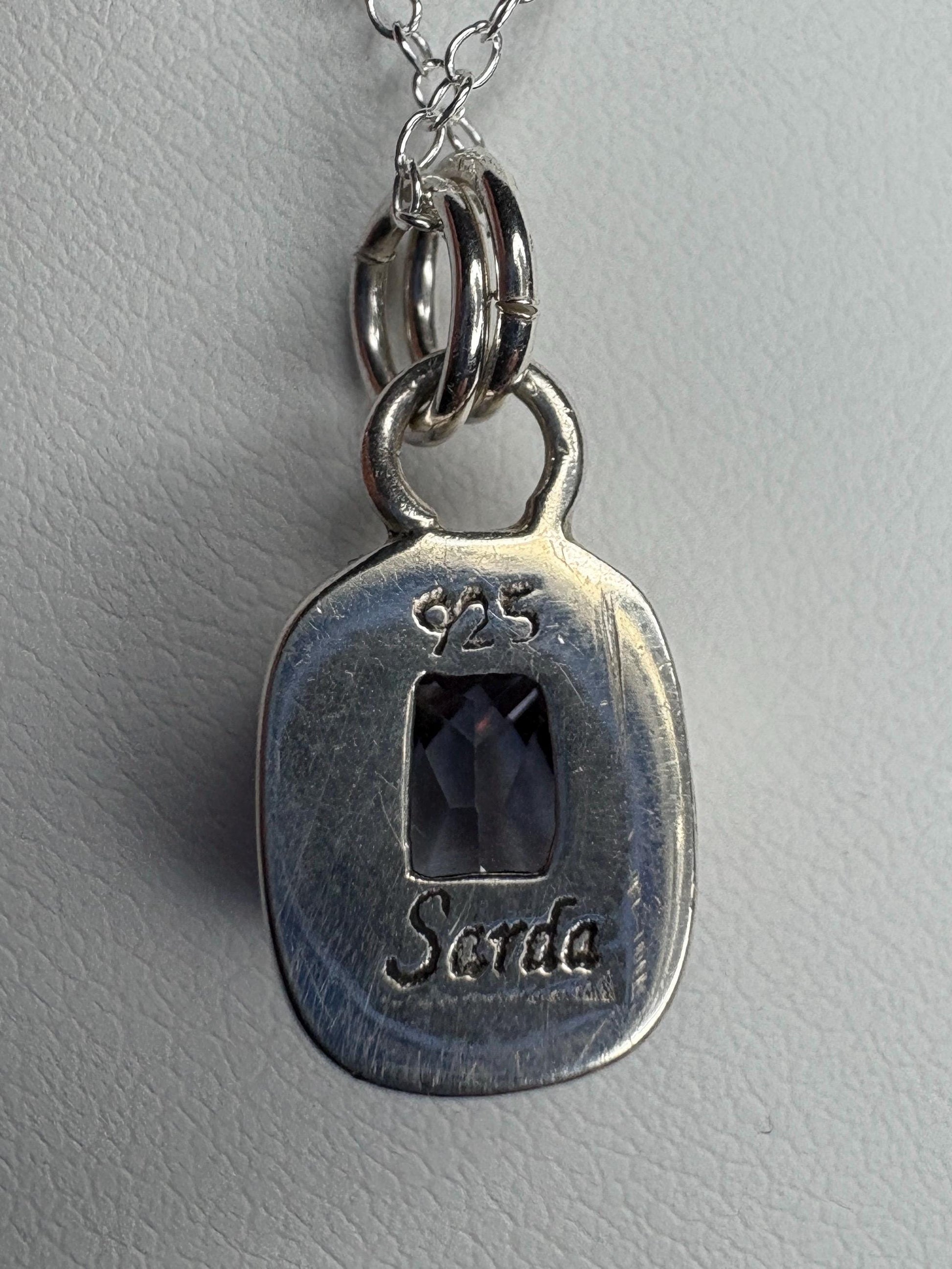 Sterling silver pendant necklace with a lavender checkerboard faceted CZ.