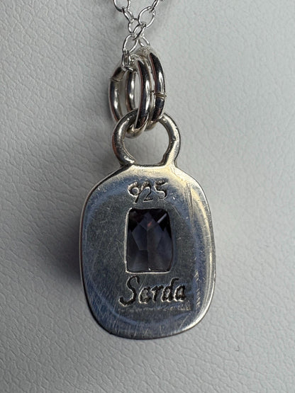 Sterling silver pendant necklace with a lavender checkerboard faceted CZ.
