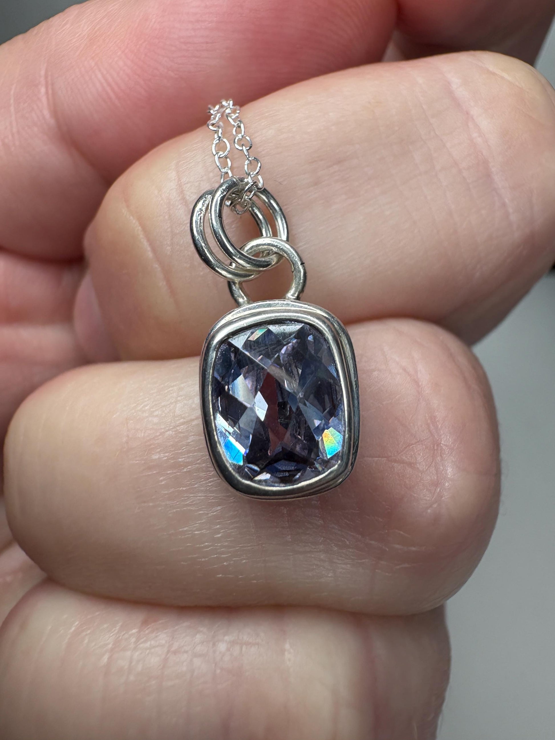 Sterling silver pendant necklace with a lavender checkerboard faceted CZ.