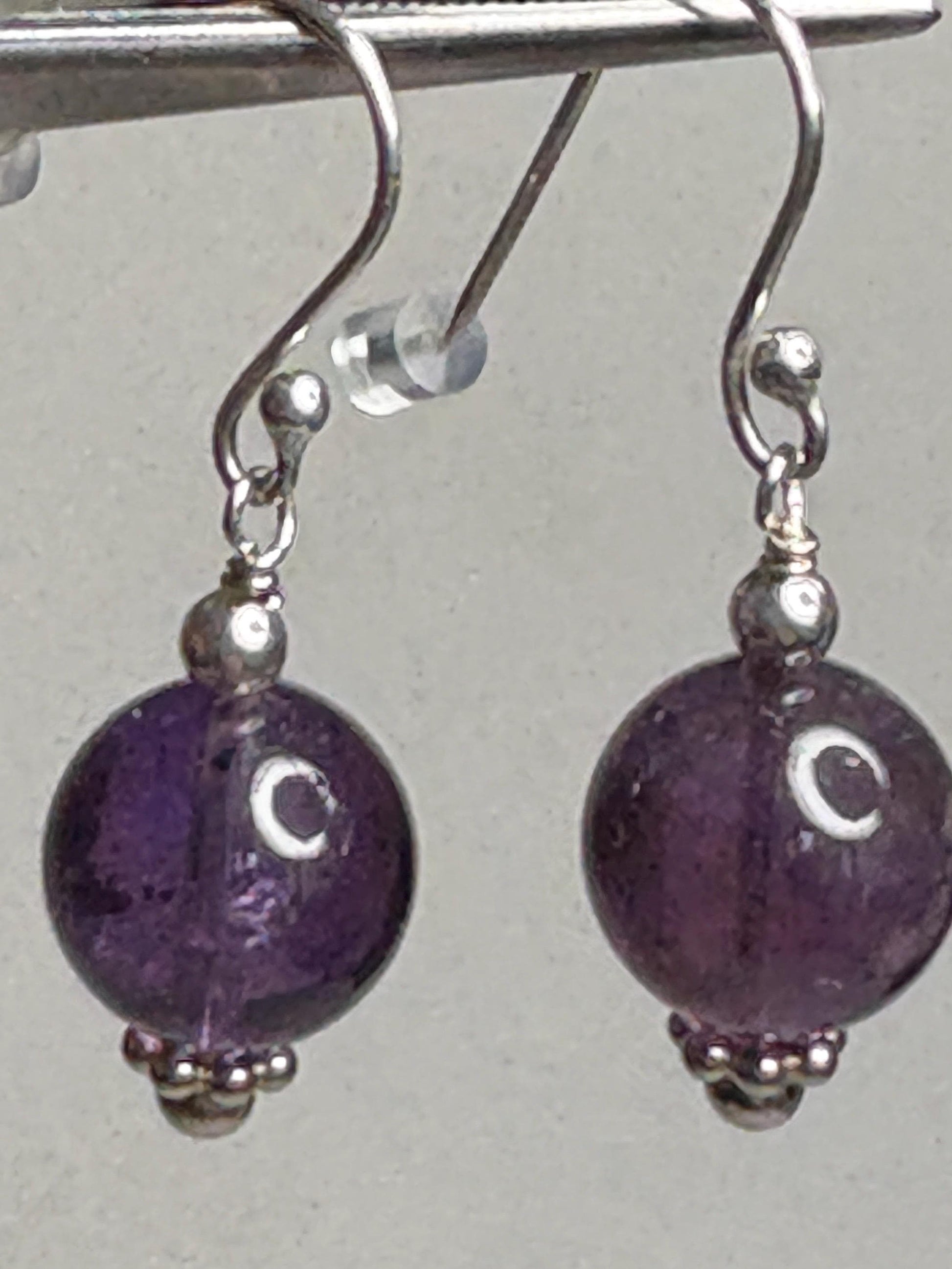 Sterling silver dangle earrings with 10mm natural amethyst beads.