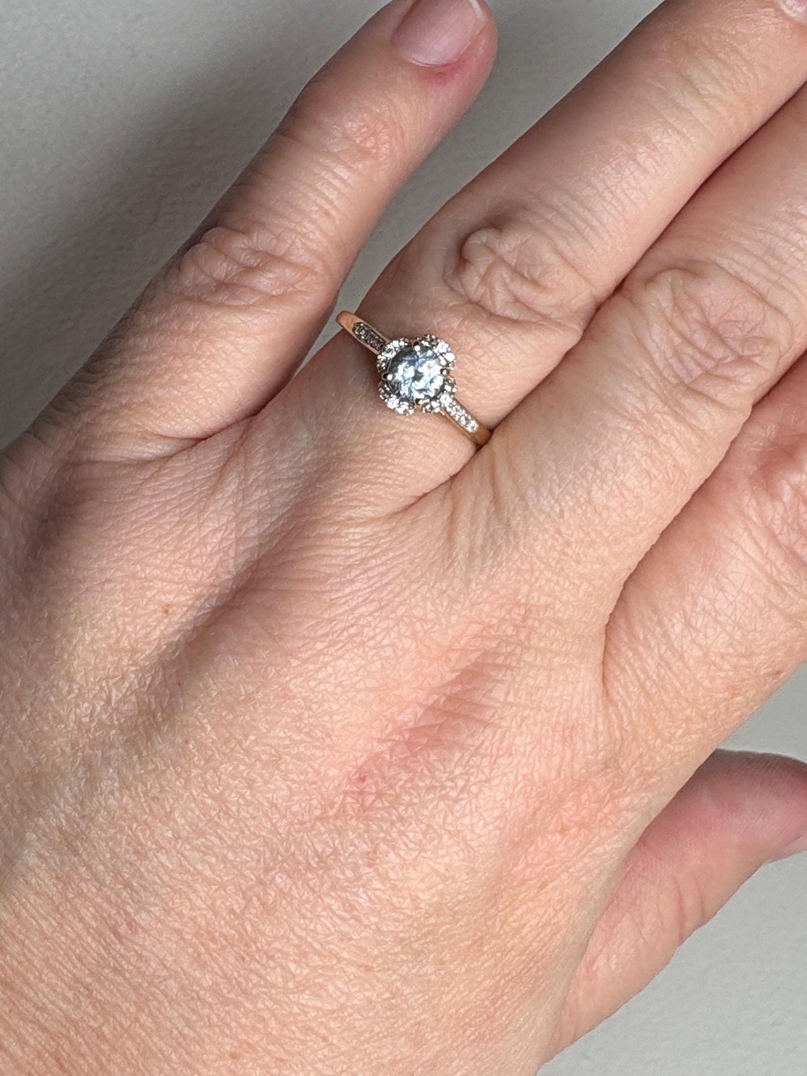 A 9k gold ring with a Montana sapphire and white zircon halo.