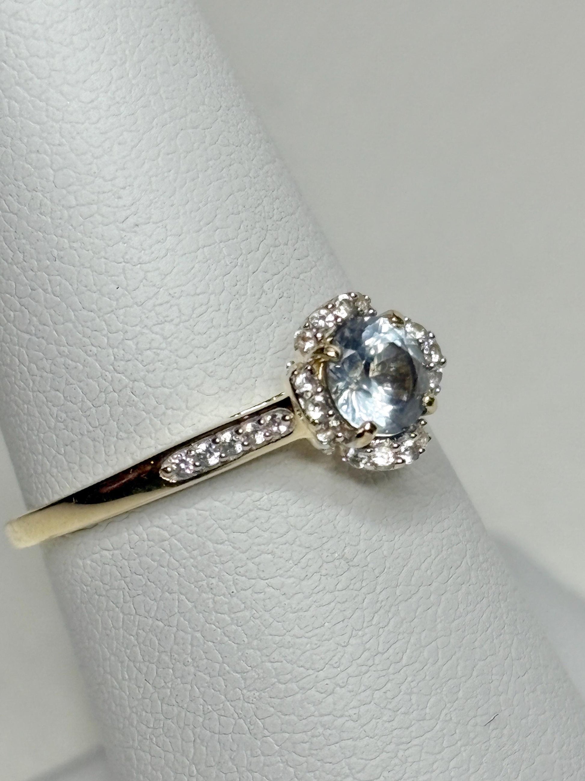 A 9k gold ring with a Montana sapphire and white zircon accents.