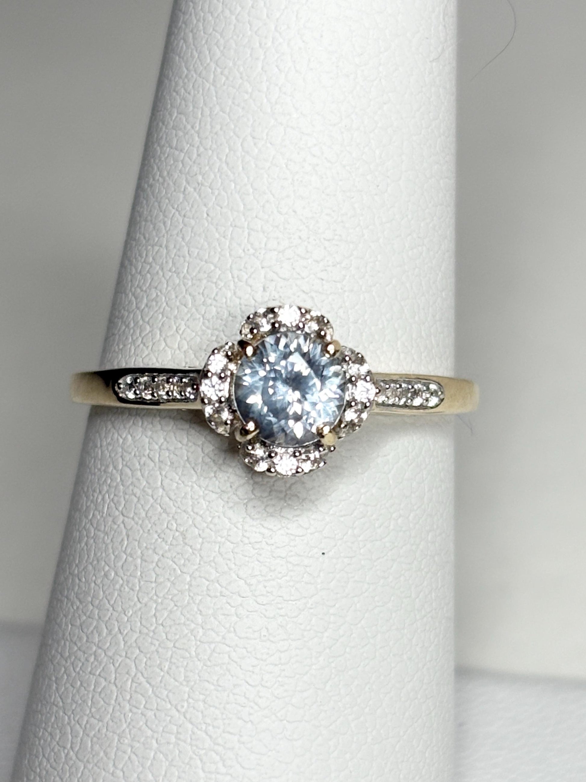 A 9k gold ring with a Montana sapphire and white zircon halo.